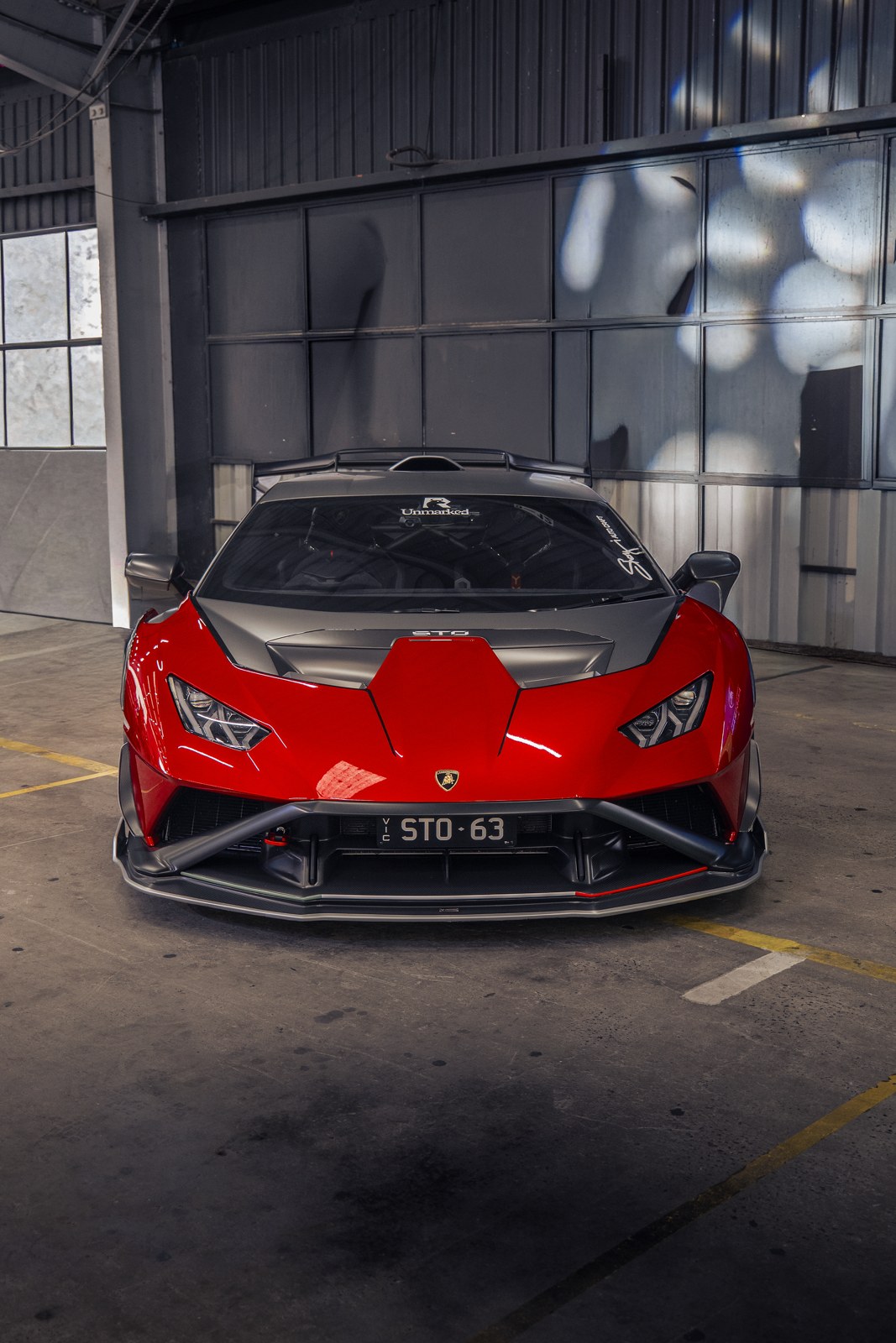 Red Lamborghini Huracan STO inside an industrial shed