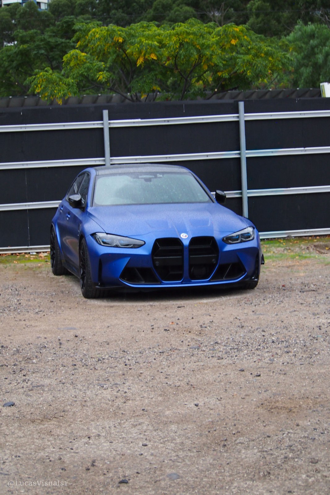 Blue BMW M4 on a gravel road