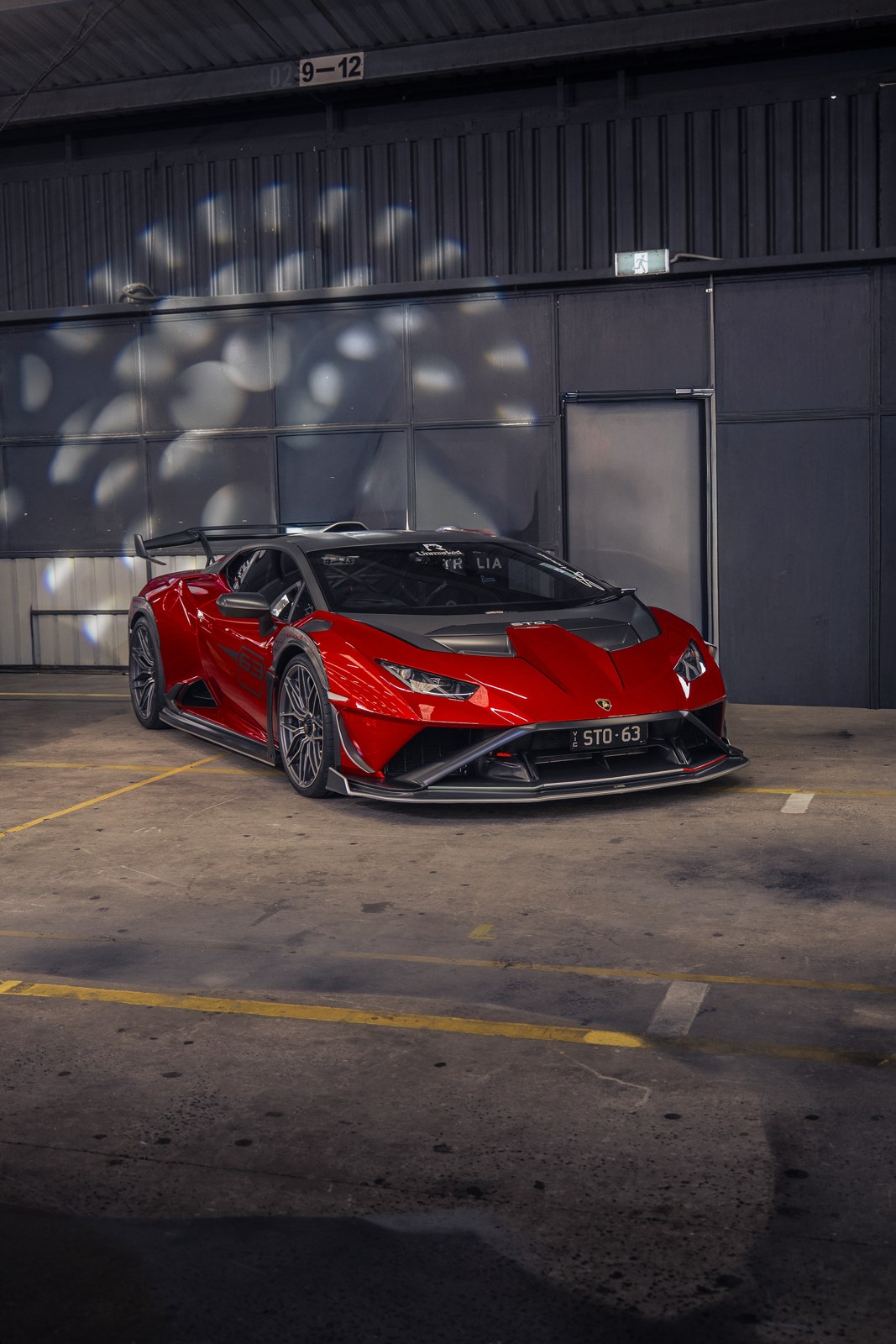 Red Lamborghini Huracan STO outside a warehouse