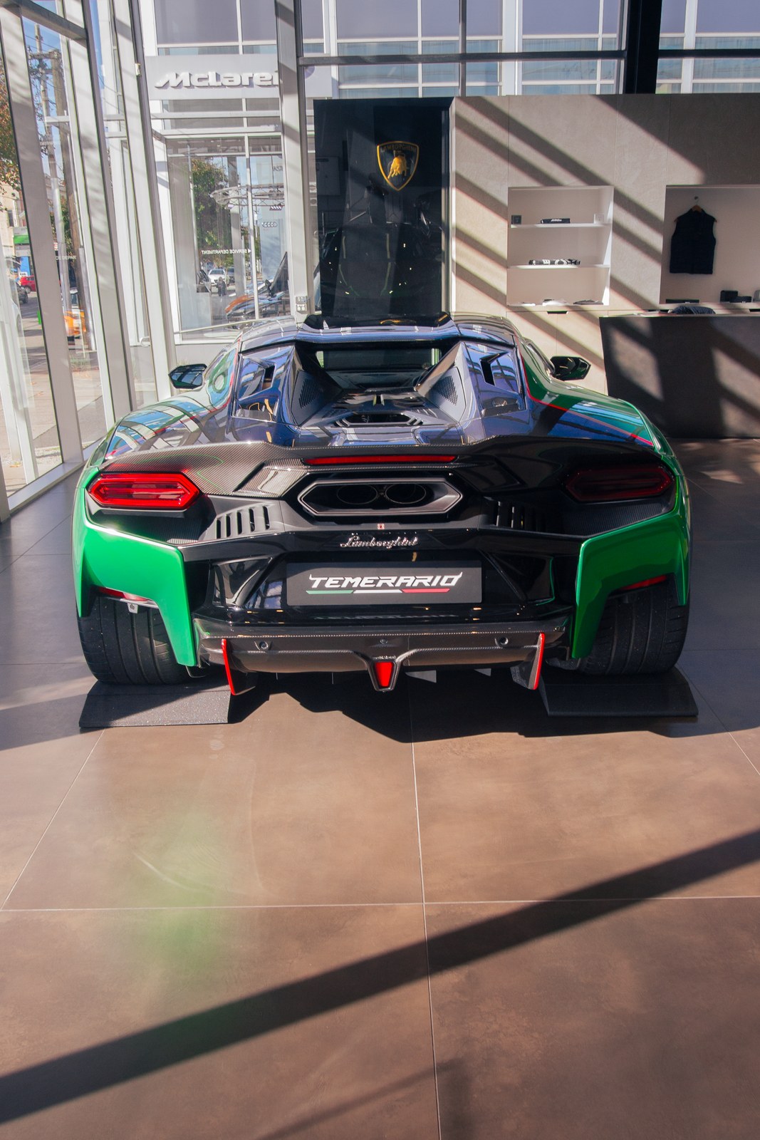 Rear wing detail of a green and black supercar