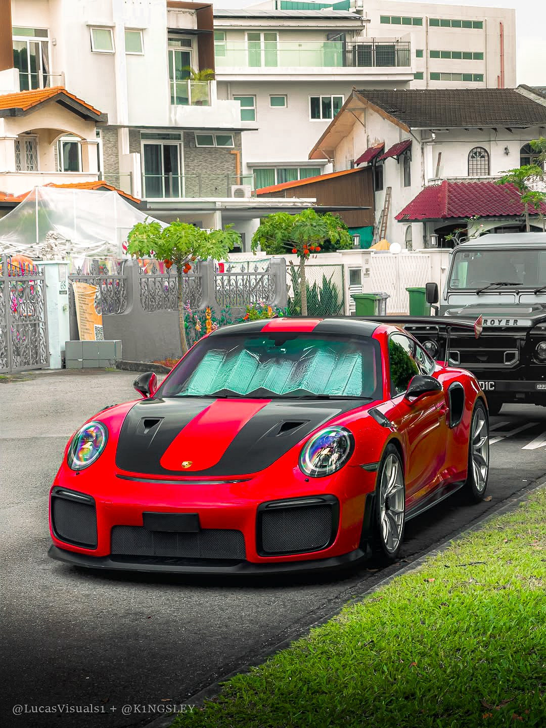 Red Porsche 911 GT2 RS parked on grass