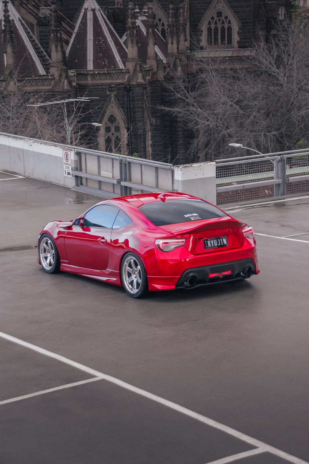 Red Honda Civic Type R on a wet city street