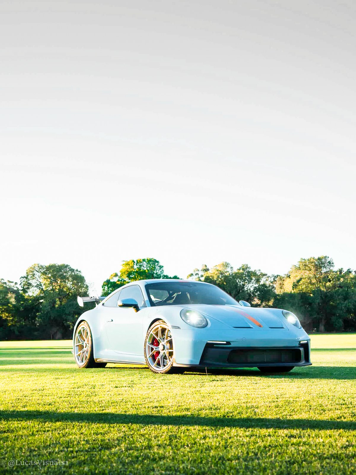 White Porsche 911 parked on a lawn